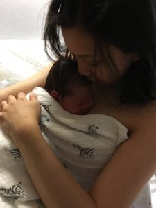 Nina cradling her newborn baby after her amazing hypnobirth
