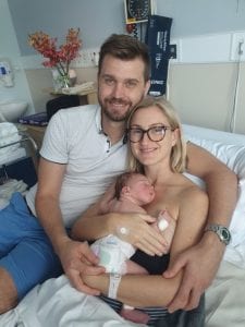 New parents Erin & Tyson holding baby Odette