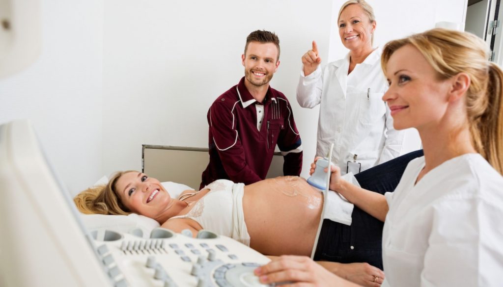 Couple and Doctors Looking at Ultrasound