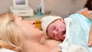 Mom and newborn baby skin to the skin after birth