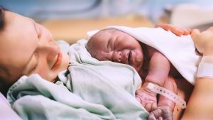 Positive Caesarean Birth - Mother and Newborn Child Birth in Maternity Hospital. Young Mom