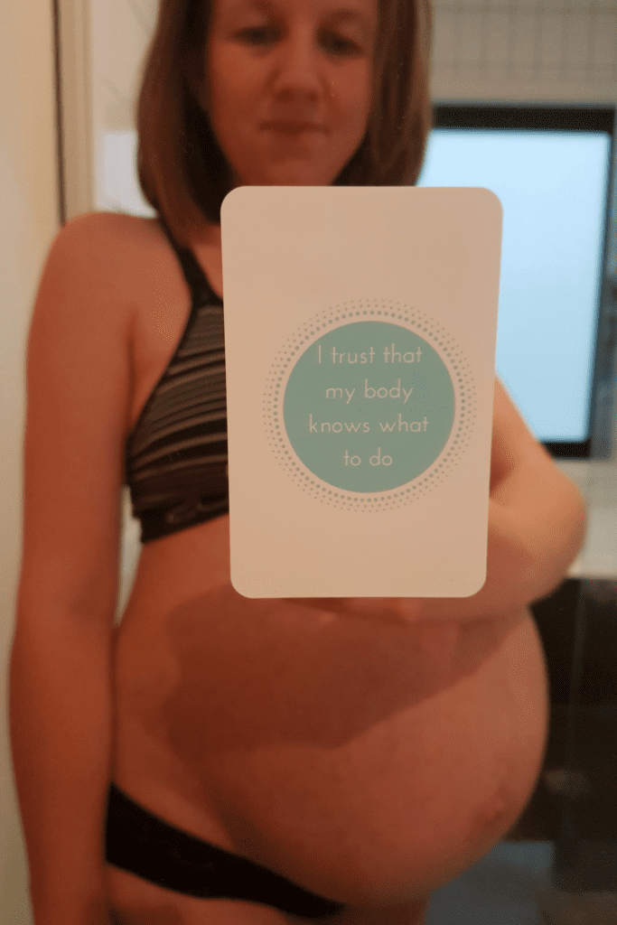 Elyse showing her pregnancy affirmation cards